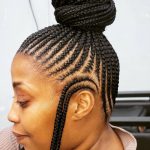 A woman with a neat bun hairstyle.